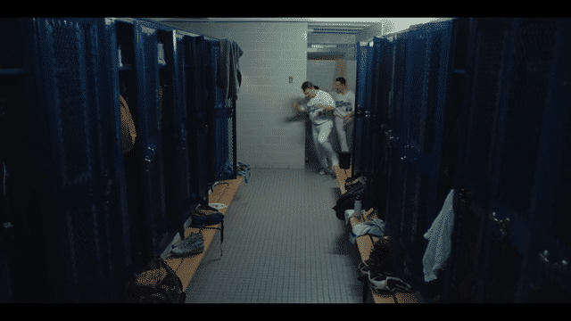 Interior high school locker room with team celebrating